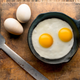 Two fried eggs in a pan